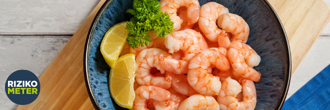 Young pregnant woman with ice cream bucket sitting on sofa at home, closeup