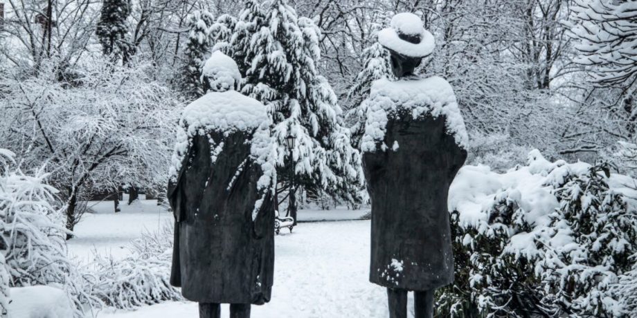 Snow-covered,Statues,In,Winter,Park.,Two,Human,Figures,Under,Thick