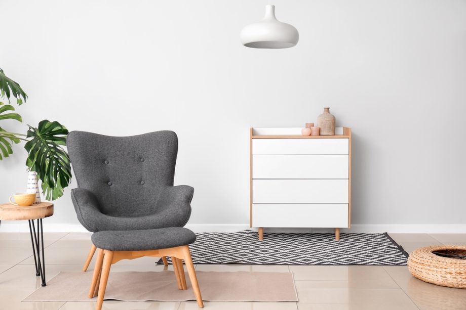 Stylish,Armchair,And,Ottoman,With,Chest,Of,Drawers,In,Interior